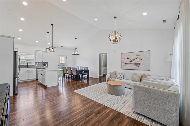 a living room with furniture and kitchen view