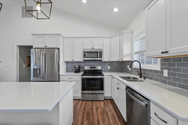 a kitchen with a sink stainless steel appliances and cabinets