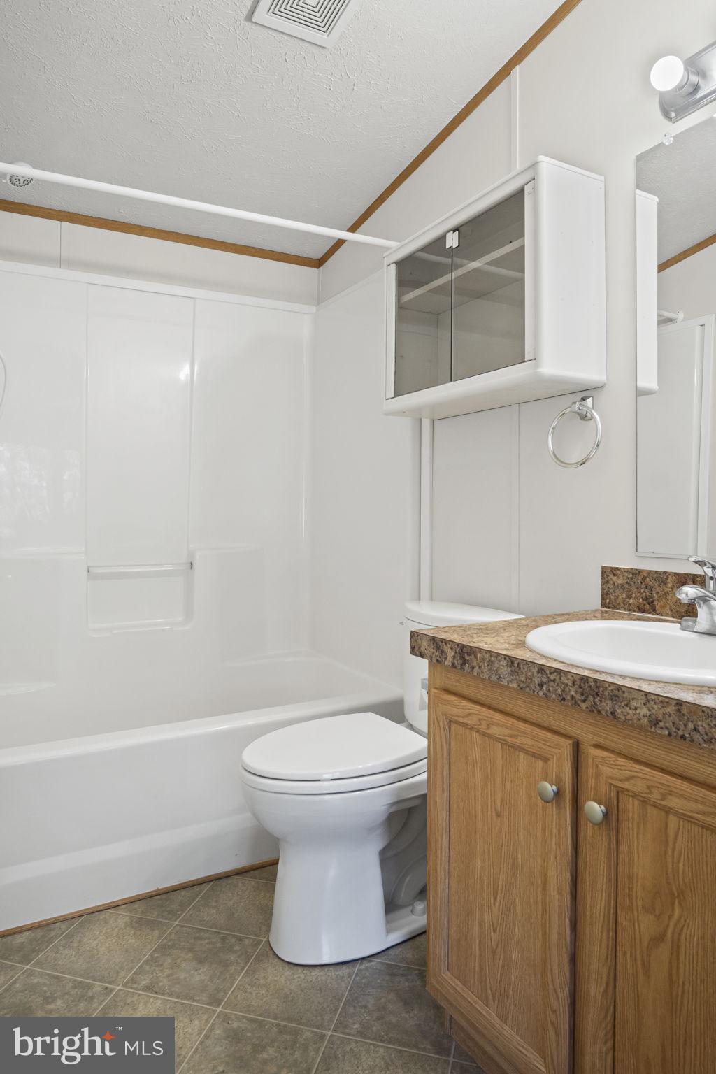 540 Zeigler Road Dover, PA 17315 - Photo 27 of 41 a bathroom with a granite countertop sink a toilet and shower