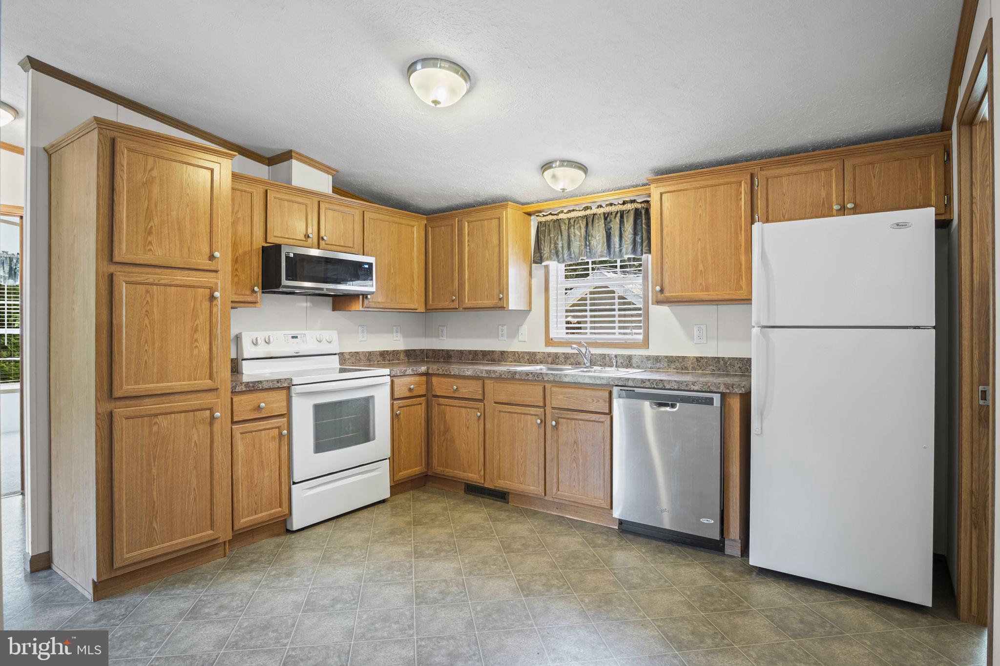540 Zeigler Road Dover, PA 17315 - Photo 29 of 41 a kitchen with white cabinets and white appliances