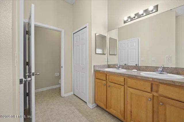 a bathroom with a double vanity sink and mirror