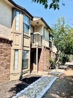 a view of a white house with large windows