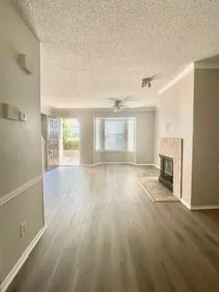 an empty room with windows and fireplace
