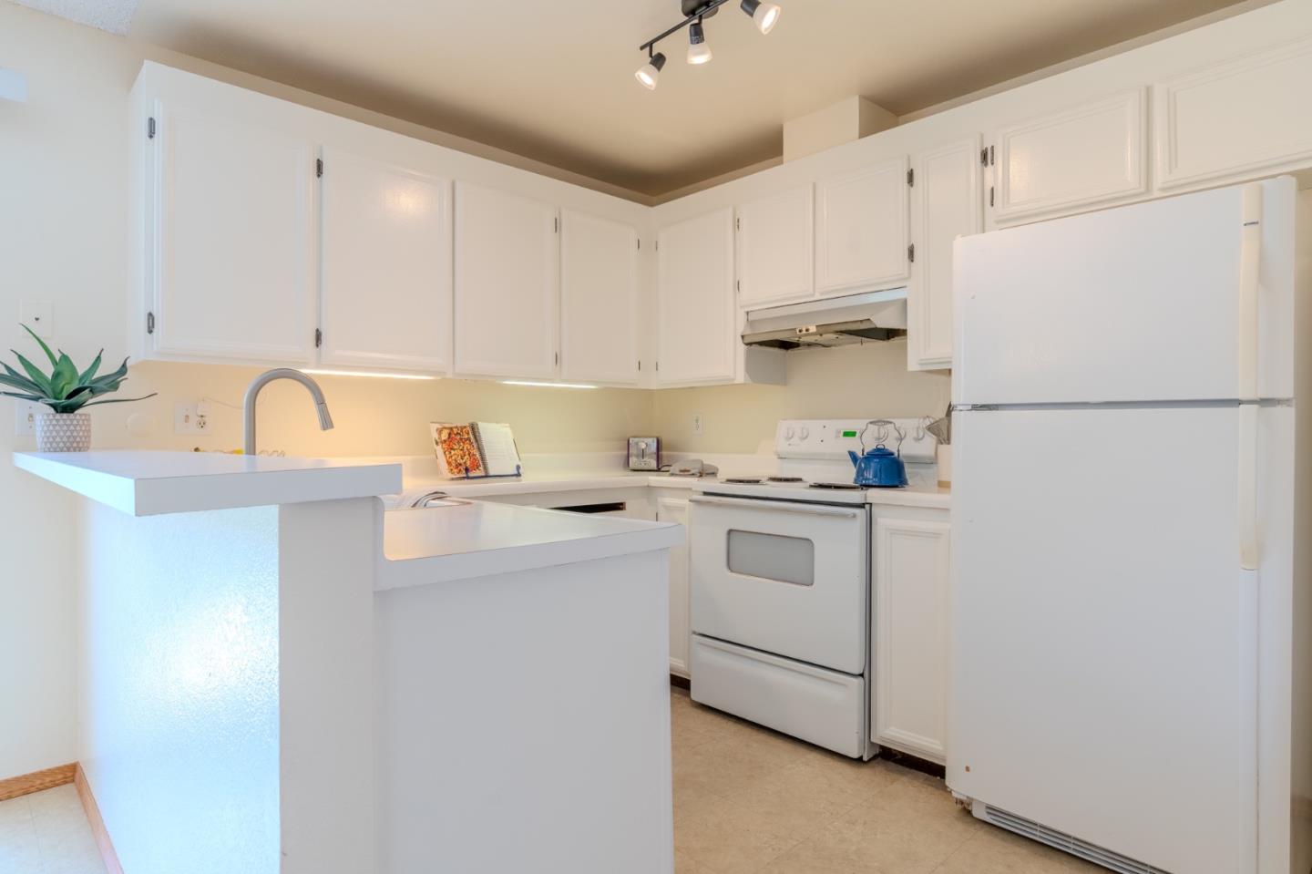 1263 Rosita Road Pacifica, CA 94044 - Photo 12 of 37 a kitchen with cabinets appliances and a sink