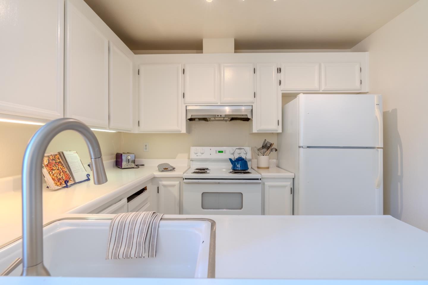 1263 Rosita Road Pacifica, CA 94044 - Photo 14 of 37 a kitchen with stainless steel appliances granite countertop a refrigerator and a stove top oven