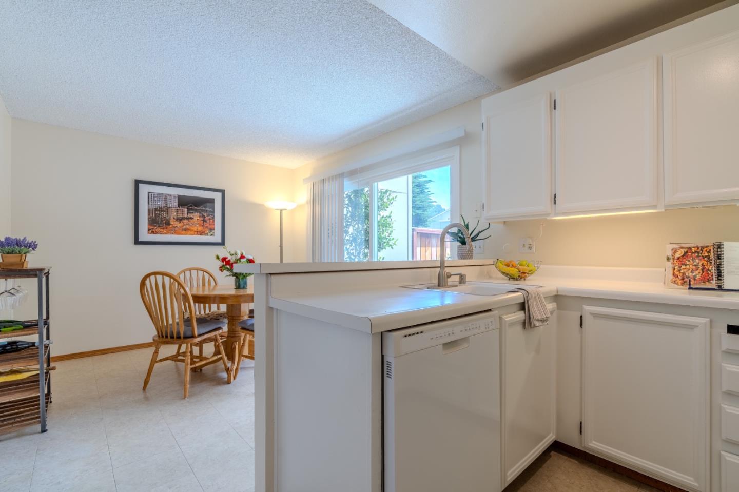 1263 Rosita Road Pacifica, CA 94044 - Photo 15 of 37 a kitchen with stainless steel appliances granite countertop a sink and a refrigerator