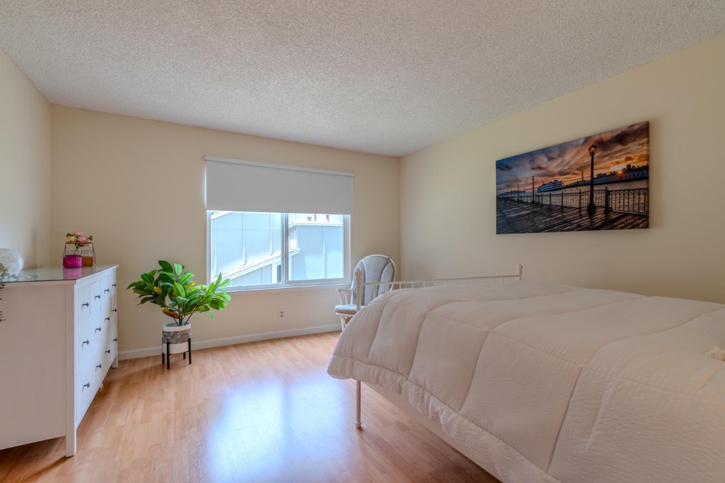 1263 Rosita Road Pacifica, CA 94044 - Photo 20 of 37 a bed sitting in a spacious bedroom next to a window