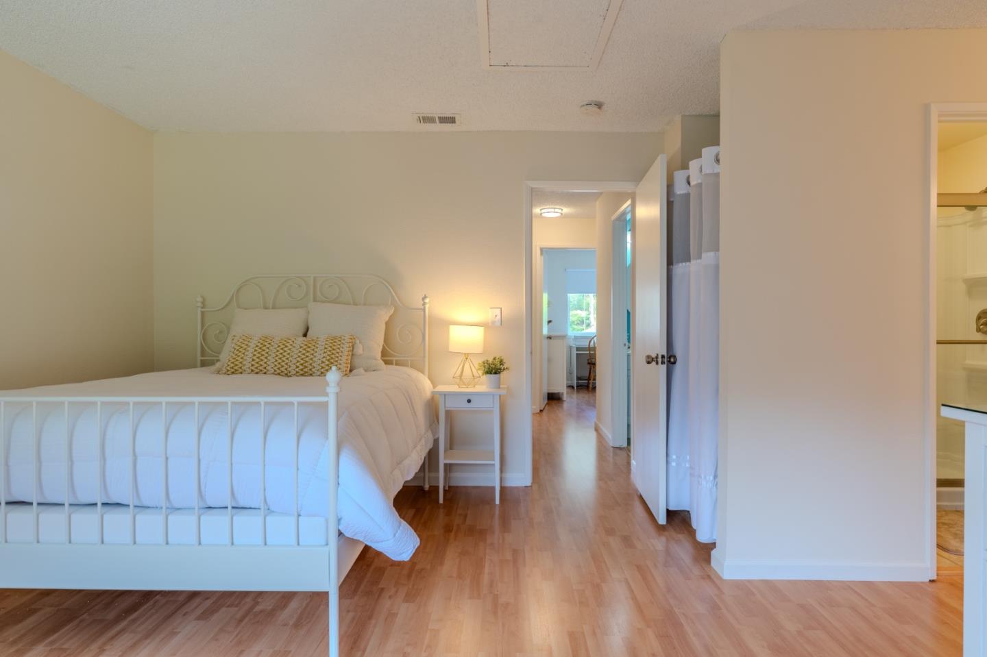 1263 Rosita Road Pacifica, CA 94044 - Photo 22 of 37 a bedroom with a bed and a wooden floor