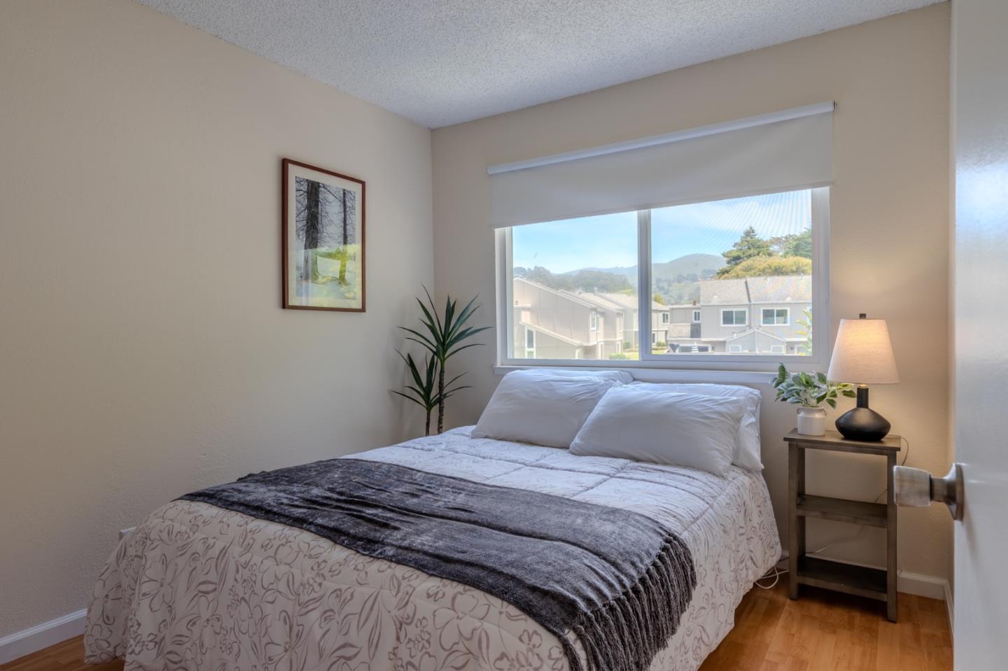 1263 Rosita Road Pacifica, CA 94044 - Photo 26 of 37 a bedroom with a bed and a large window