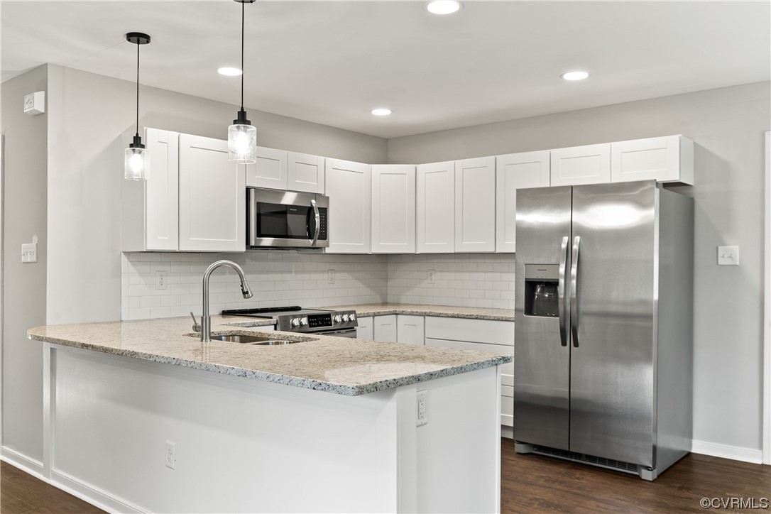 15406 Saddlebrook Road Chesterfield, VA 23838 - Photo 11 of 36 a kitchen with granite countertop a refrigerator a microwave a sink and cabinets