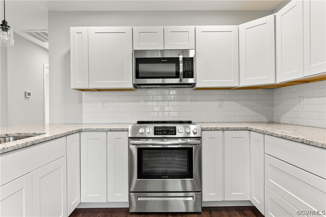 15406 Saddlebrook Road Chesterfield, VA 23838 - Photo 14 of 36 a kitchen with white cabinets and stainless steel appliances