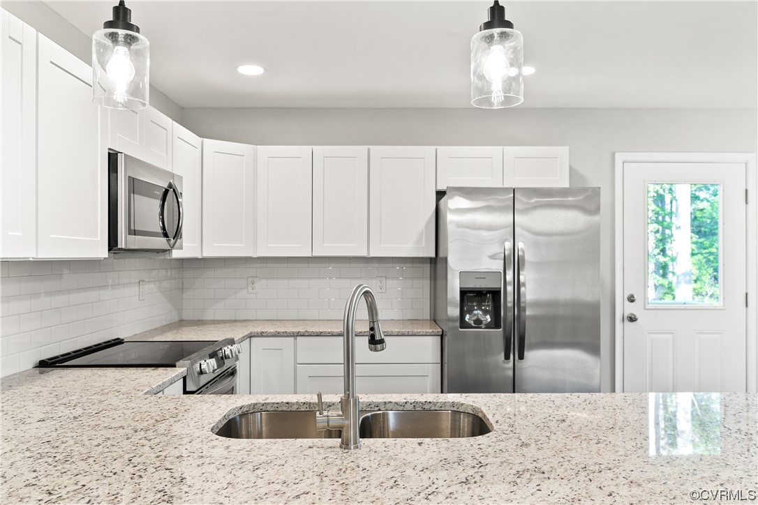 15406 Saddlebrook Road Chesterfield, VA 23838 - Photo 16 of 36 a kitchen with stainless steel appliances granite countertop a sink refrigerator and microwave