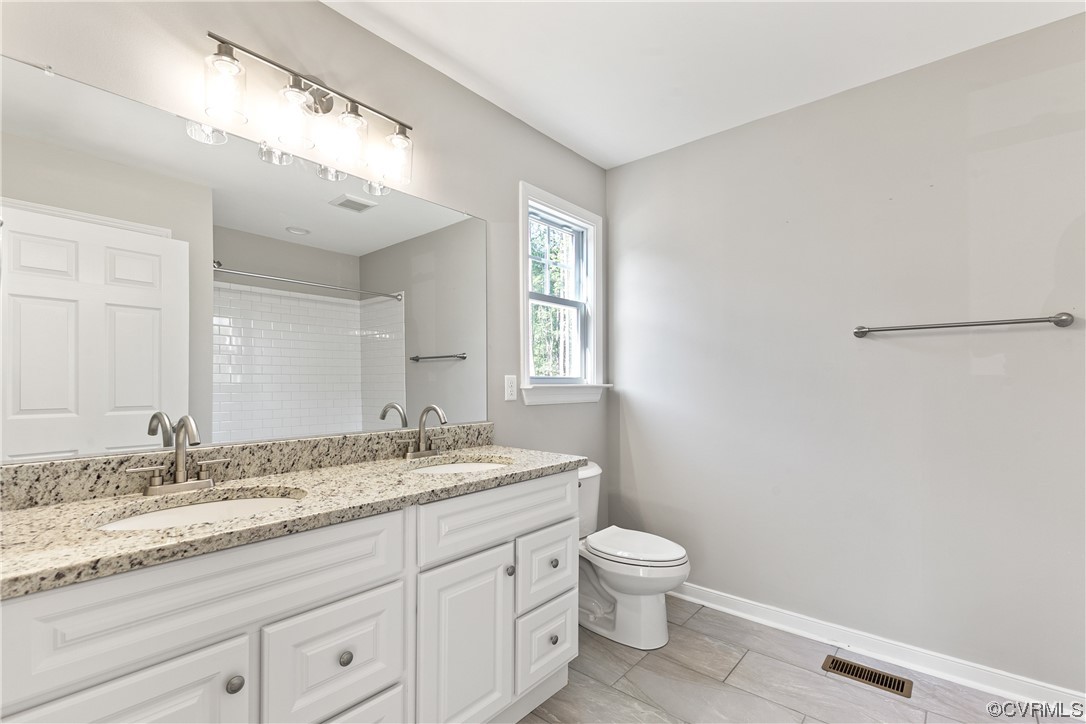 15406 Saddlebrook Road Chesterfield, VA 23838 - Photo 23 of 36 a bathroom with a granite countertop sink mirror vanity and toilet