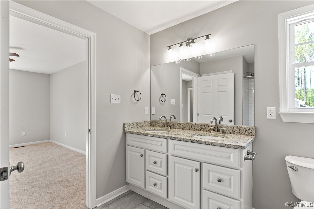 15406 Saddlebrook Road Chesterfield, VA 23838 - Photo 24 of 36 a bathroom with a granite countertop sink mirror and a toilet