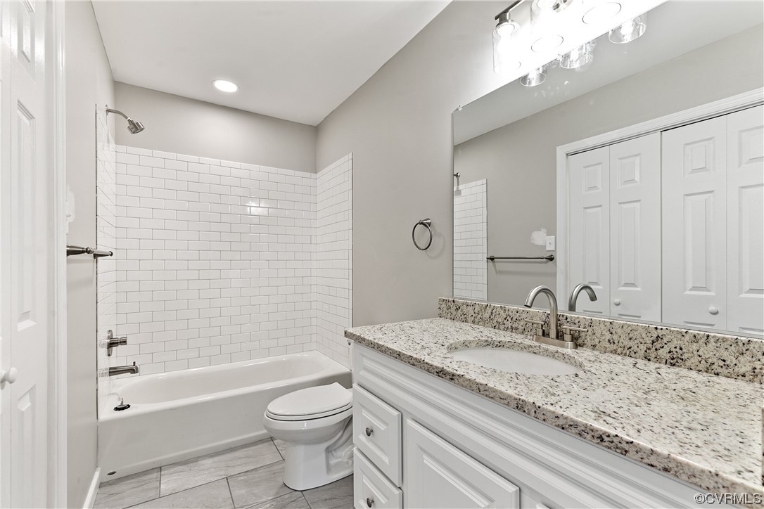 15406 Saddlebrook Road Chesterfield, VA 23838 - Photo 28 of 36 a bathroom with a granite countertop sink a toilet and bathtub