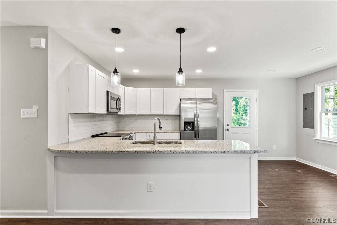 15406 Saddlebrook Road Chesterfield, VA 23838 - Photo 9 of 36 a kitchen with kitchen island granite countertop a stove a sink and white cabinets with wooden floor