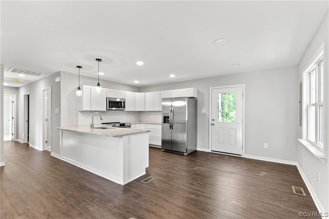 15406 Saddlebrook Road Chesterfield, VA 23838 - Photo 10 of 36 a kitchen with stainless steel appliances kitchen island wooden floors refrigerator and stove