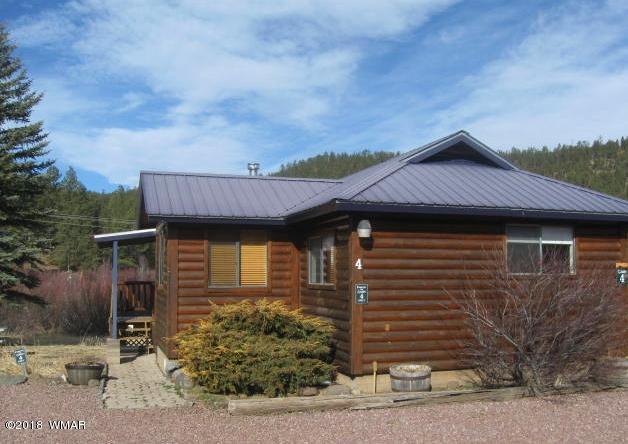 140 Main Street, Unit 4 Greer, AZ 85927 - Photo 1 of 20 a front view of a house with garden