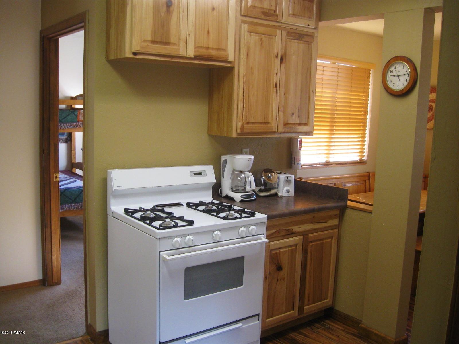 140 Main Street, Unit 4 Greer, AZ 85927 - Photo 11 of 20 a stove top oven sitting inside of a kitchen