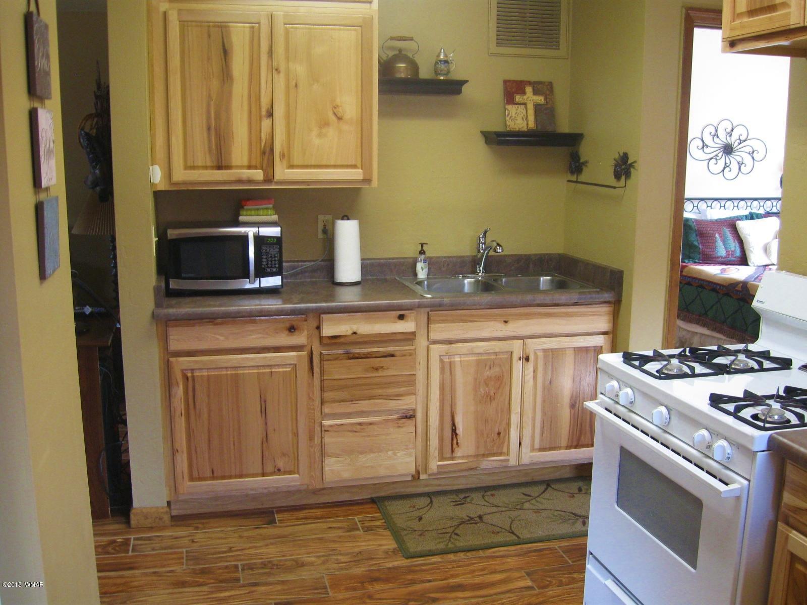 140 Main Street, Unit 4 Greer, AZ 85927 - Photo 12 of 20 a kitchen with stainless steel appliances granite countertop a stove a sink and a microwave