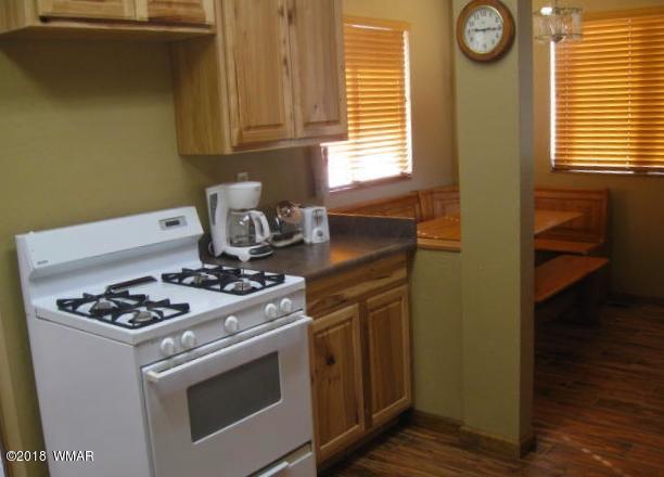 140 Main Street, Unit 4 Greer, AZ 85927 - Photo 13 of 20 a white stove top oven sitting inside of a kitchen