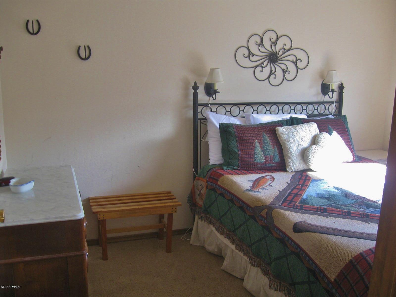140 Main Street, Unit 4 Greer, AZ 85927 - Photo 16 of 20 a bedroom with a bed and a table