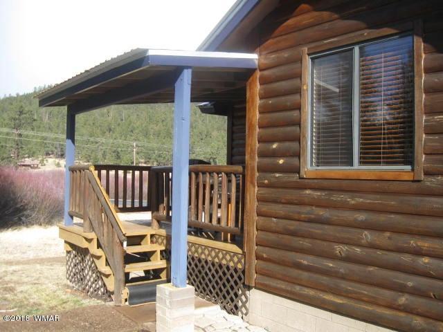 140 Main Street, Unit 4 Greer, AZ 85927 - Photo 3 of 20 a front view of a house with a porch