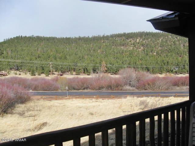 140 Main Street, Unit 4 Greer, AZ 85927 - Photo 6 of 20 a view of a lake from a yard