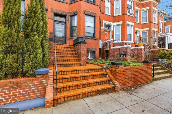 a view of a brick building with many windows