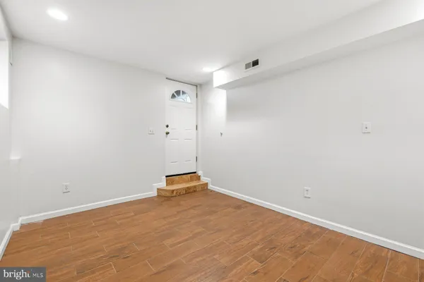 a view of a room with wooden floor