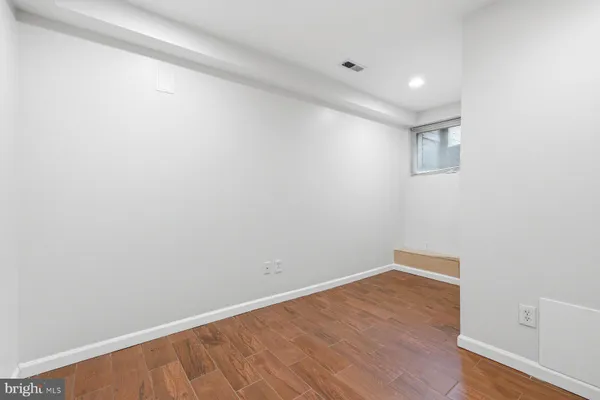 a view of room with wooden floor