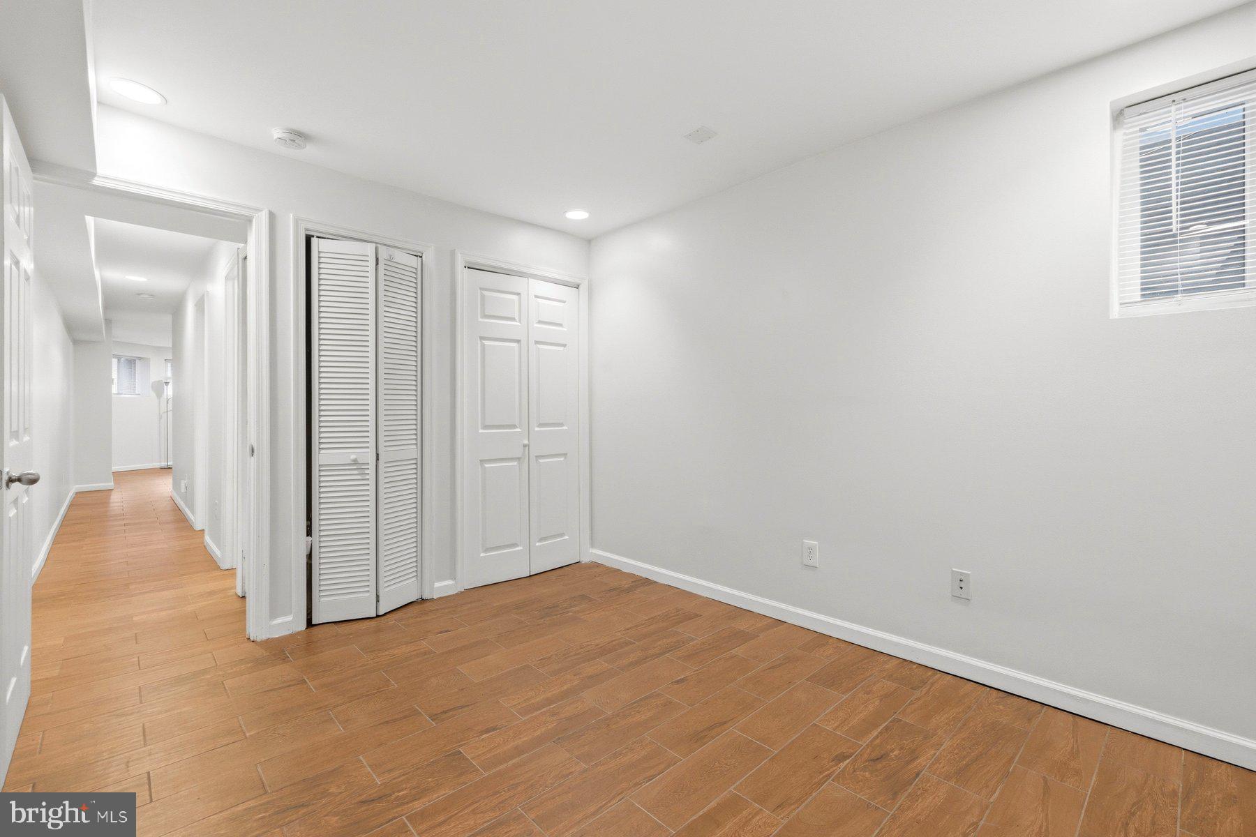 145 Randolph Place Northwest, Unit B Washington, DC 20001 - Photo 18 of 20 an empty room with wooden floor and windows
