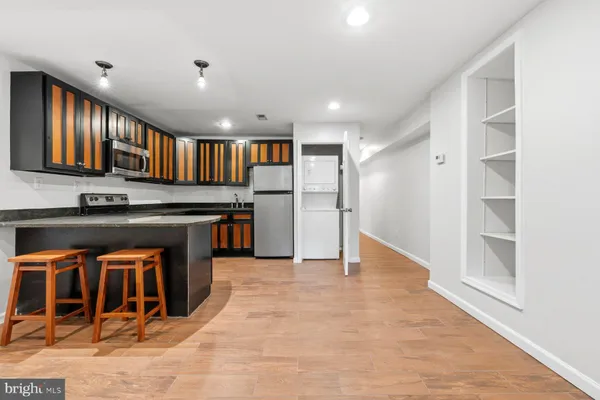 a view of kitchen with stainless steel appliances cabinets and outdoor space