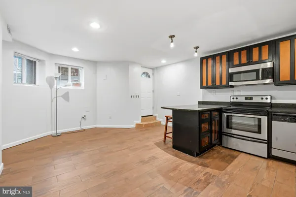 a living room with stainless steel appliances kitchen island granite countertop furniture and a kitchen view