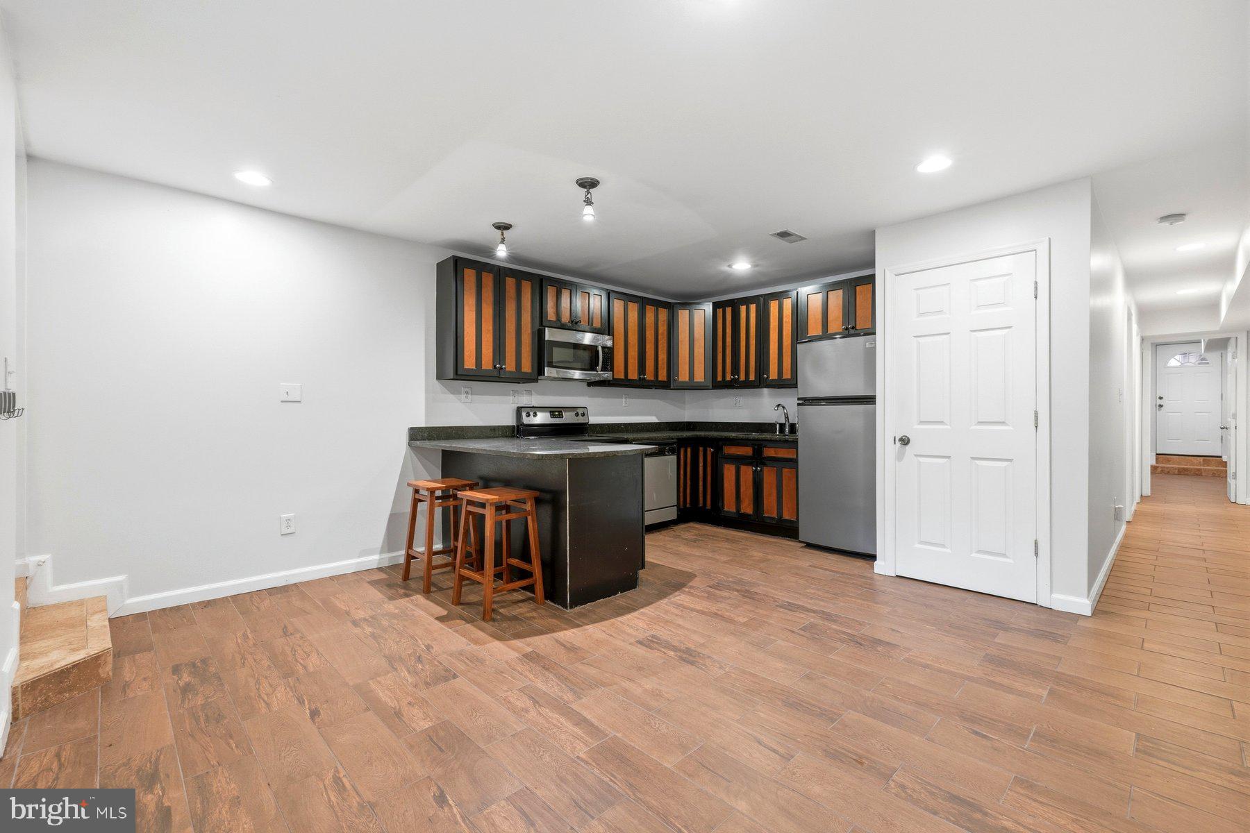 145 Randolph Place Northwest, Unit B Washington, DC 20001 - Photo 6 of 20 a kitchen with stainless steel appliances granite countertop a refrigerator and a stove top oven