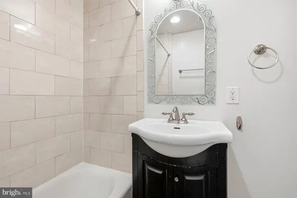 a bathroom with a sink a toilet and mirror