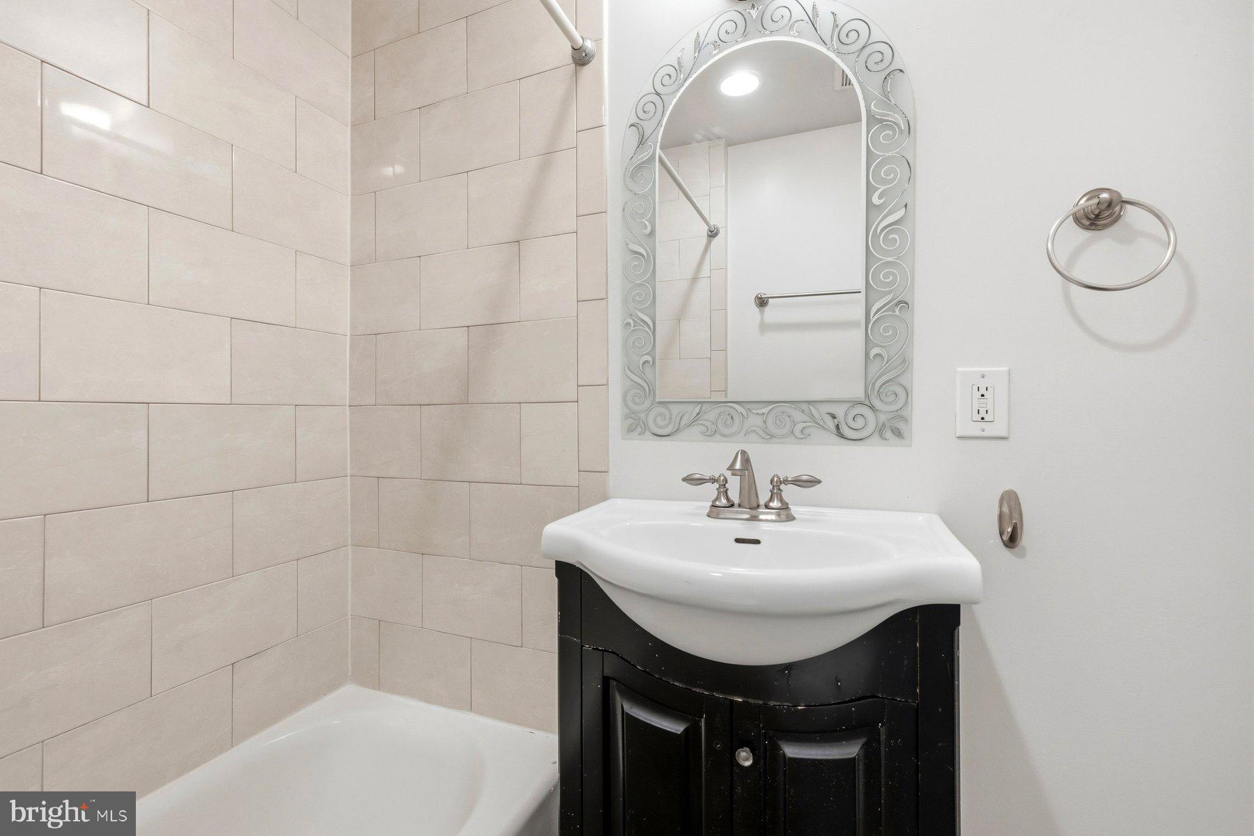 145 Randolph Place Northwest, Unit B Washington, DC 20001 - Photo 9 of 20 a bathroom with a sink a toilet and mirror