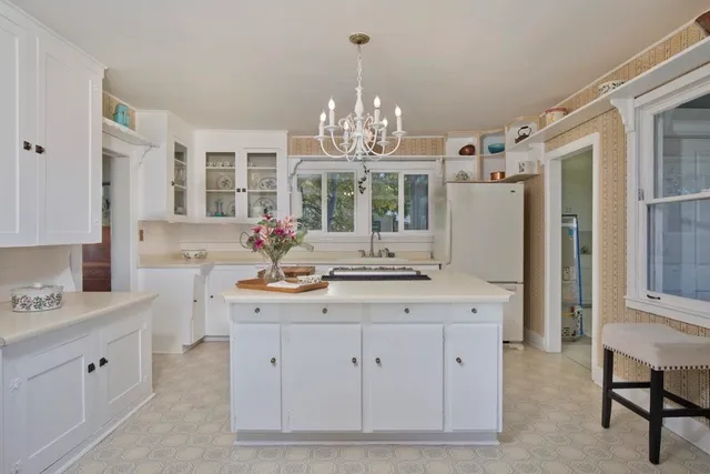 a view of a dining room with furniture and chandelier
