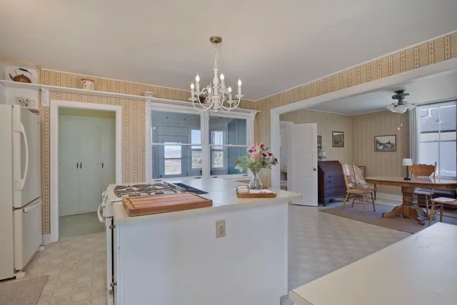 a large white kitchen with a large window