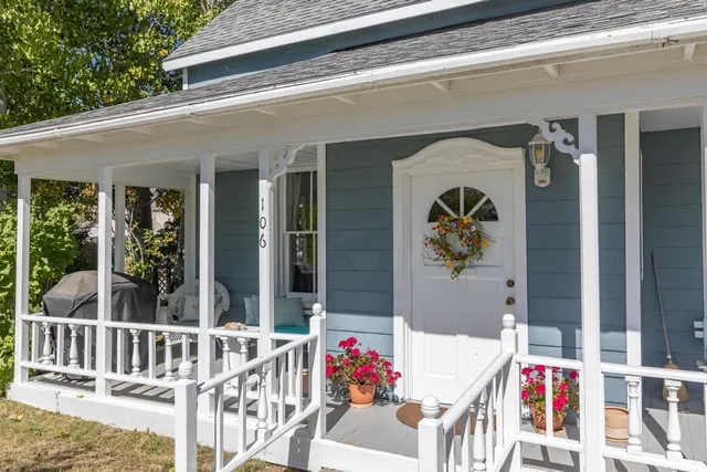 a front view of a house with a garden and deck