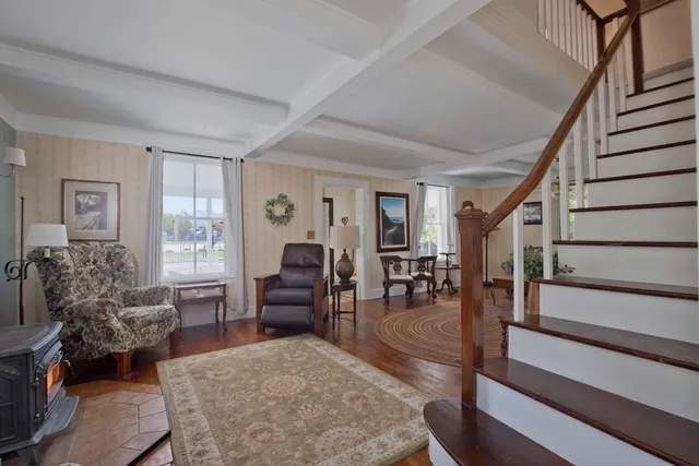 a view of a hallway and a livingroom with furniture