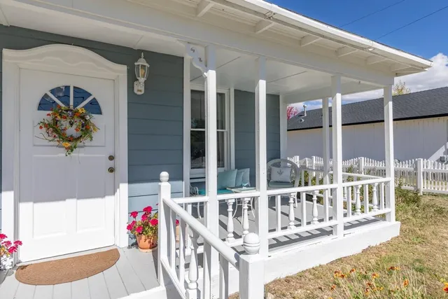 a view of a balcony dining table and chairs