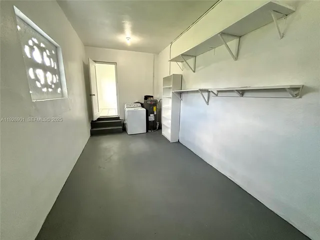 a view of a room with shelves and entryway