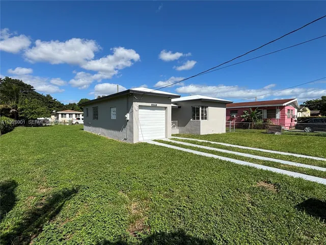 a view of a house with a backyard