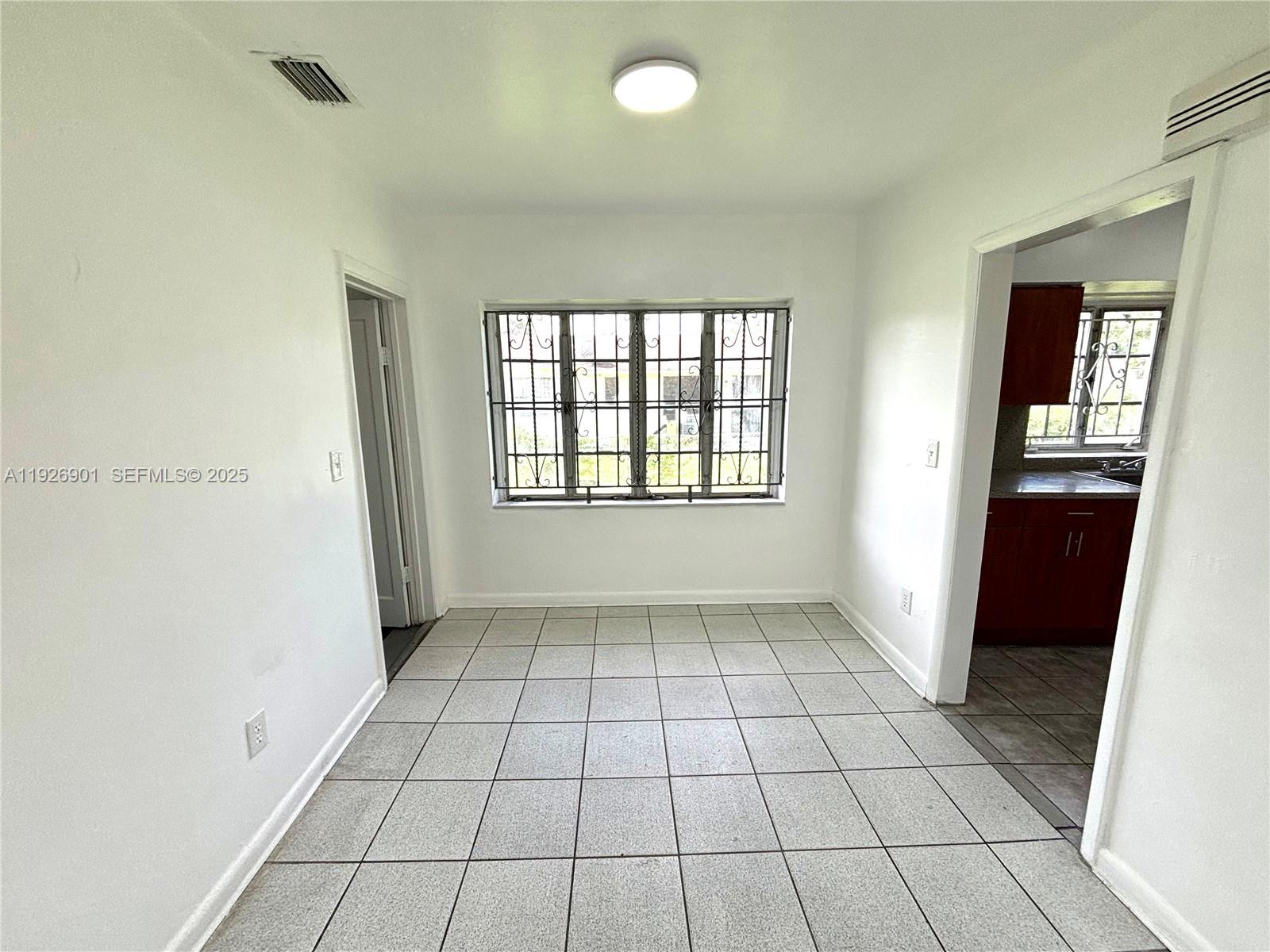 2145 Northwest 64th Street Miami, FL 33147 - Photo 7 of 21 a view of an empty room and window