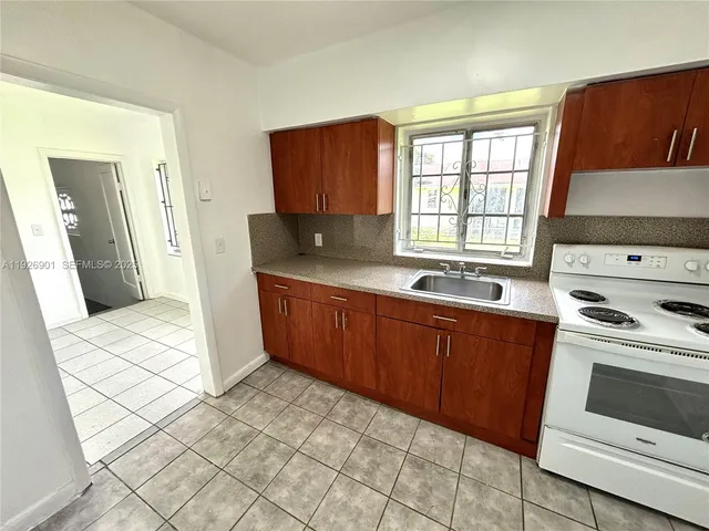 a kitchen with stainless steel appliances a stove a sink and a refrigerator