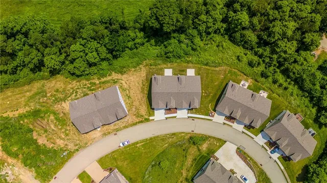 an aerial view of a house with a swimming pool