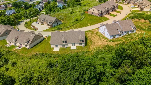 an aerial view of a house with swimming pool and garden