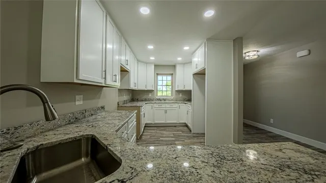 a kitchen with stainless steel appliances granite countertop a stove a sink and a refrigerator