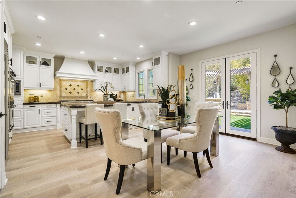 36 Blue Summit Irvine, CA 92603 - Photo 12 of 48 a dining room with furniture and a wooden floor